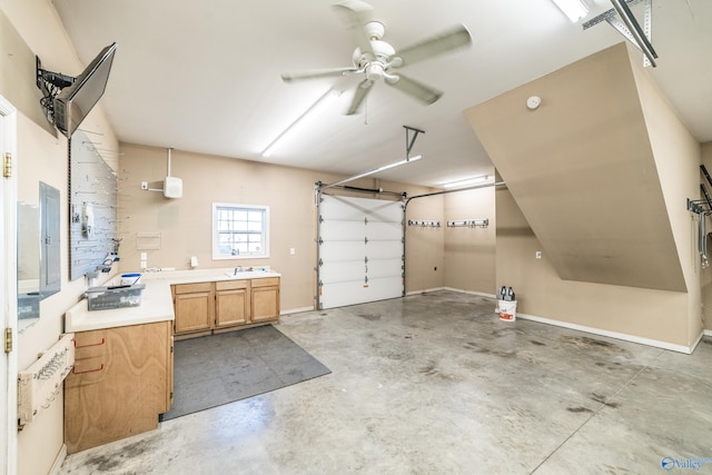 garage featuring ceiling fan and sink