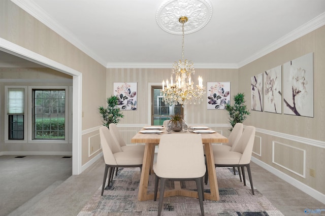 dining area featuring a notable chandelier, carpet floors, and crown molding