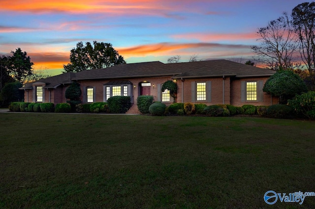 single story home featuring a yard