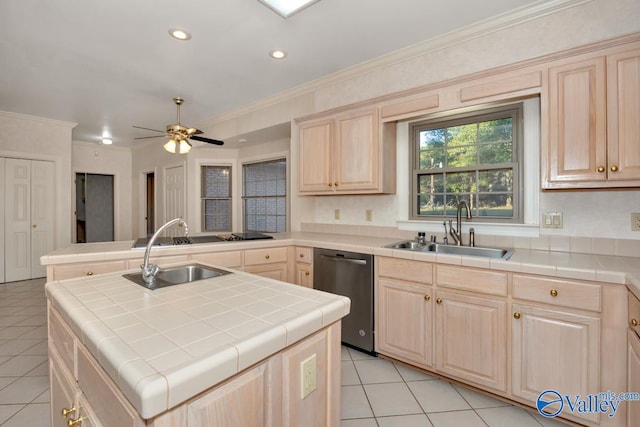 kitchen with tile countertops, dishwasher, a kitchen island, and sink