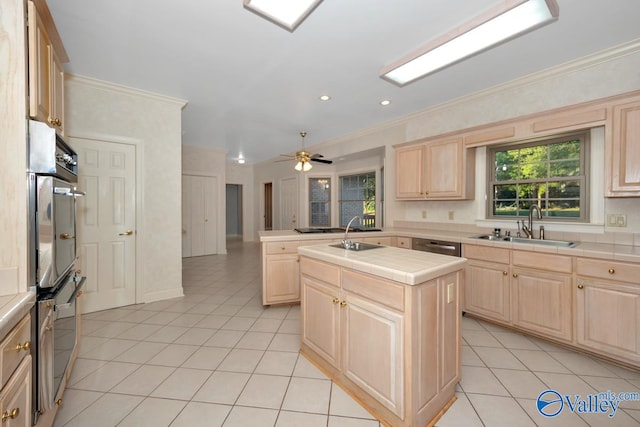 kitchen with tile countertops, crown molding, a center island, and light brown cabinets