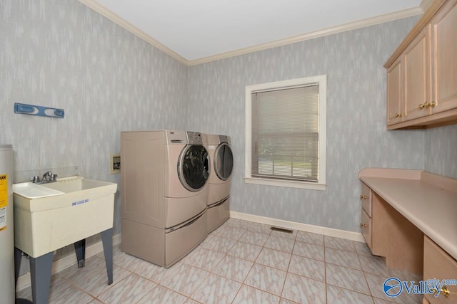 laundry room featuring sink, cabinets, gas water heater, crown molding, and washer and clothes dryer