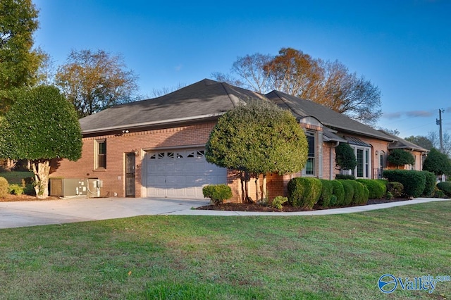 view of front of property with a front yard and a garage