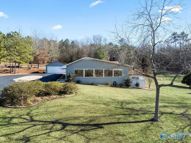 view of front of home with a garage and a front lawn