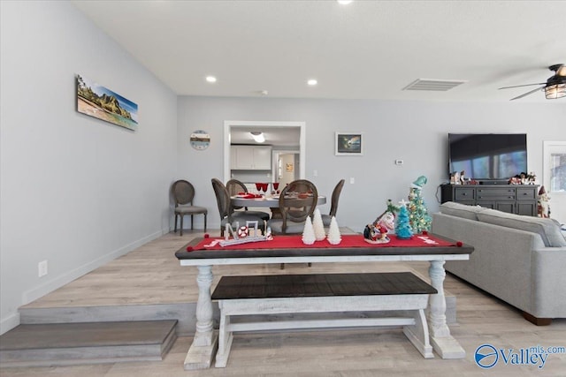 dining space with ceiling fan and light wood-type flooring