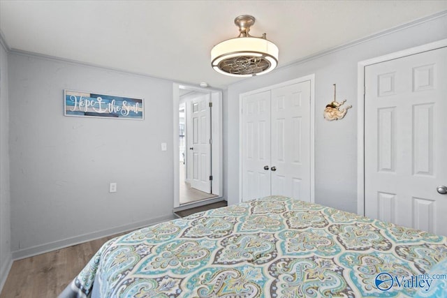 bedroom featuring hardwood / wood-style flooring, a closet, and crown molding