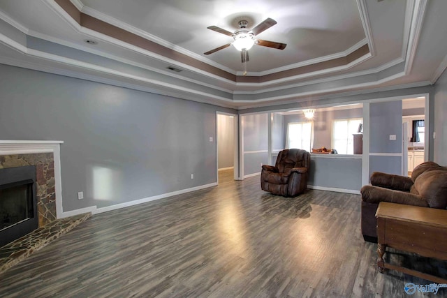 living room featuring a raised ceiling, ceiling fan, dark hardwood / wood-style floors, and ornamental molding