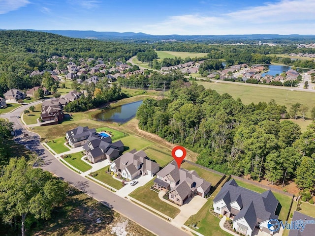 birds eye view of property with a forest view, a residential view, and a water view