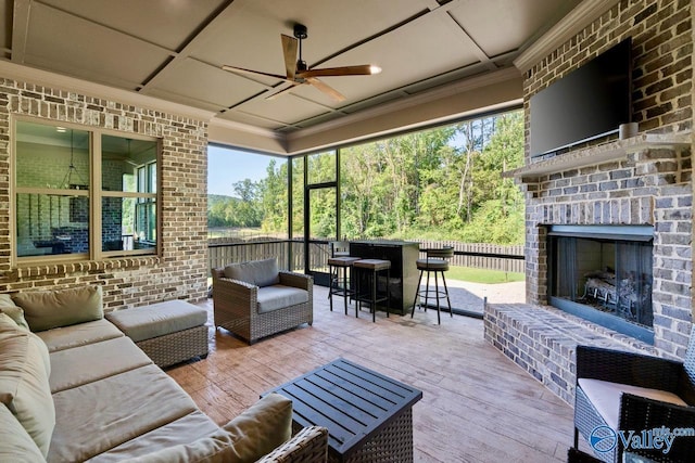 exterior space featuring coffered ceiling, ceiling fan, and an outdoor brick fireplace