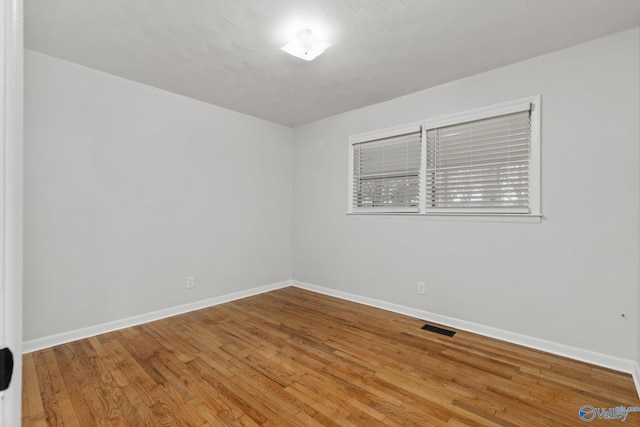 empty room with wood-type flooring