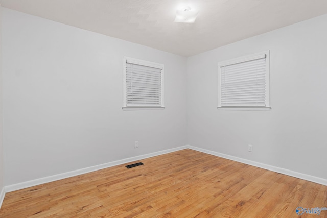 spare room with light wood-type flooring