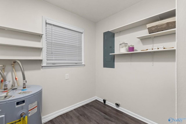 clothes washing area with electric panel, water heater, and dark hardwood / wood-style floors