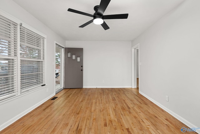 unfurnished room with light wood-type flooring and ceiling fan