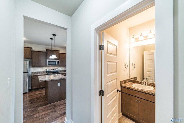 bathroom with vanity, backsplash, and hardwood / wood-style floors