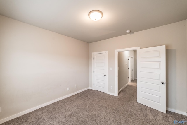 unfurnished bedroom featuring dark colored carpet