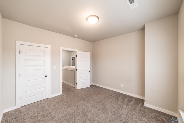 unfurnished bedroom with dark colored carpet