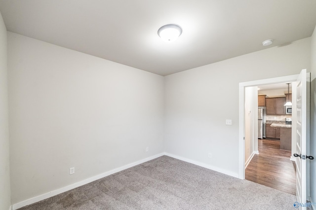 unfurnished room with carpet flooring