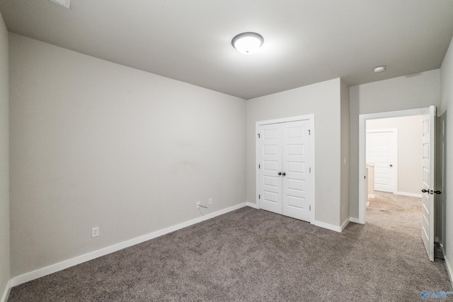 unfurnished bedroom with a closet and carpet