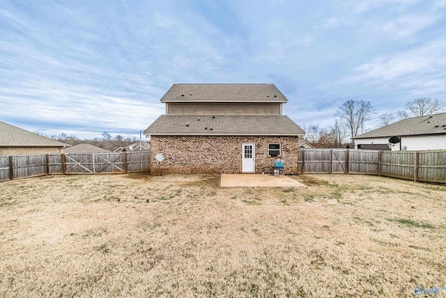 rear view of house with a yard and a patio