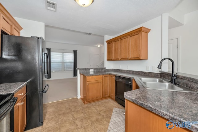 kitchen with sink, kitchen peninsula, and black appliances