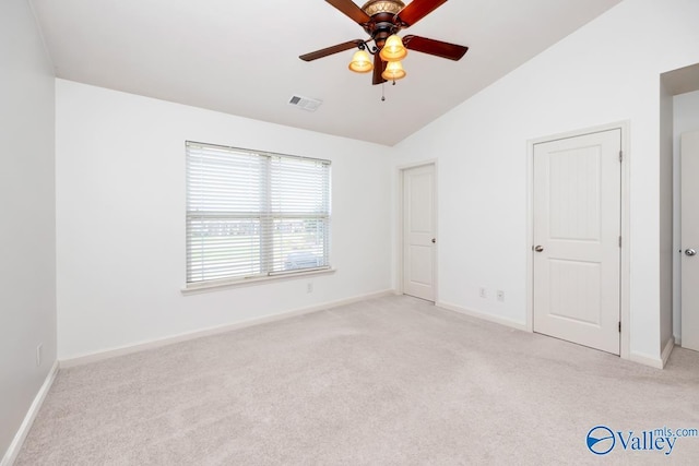 unfurnished bedroom with lofted ceiling, light carpet, and ceiling fan