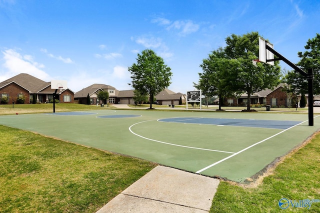 view of sport court featuring a yard