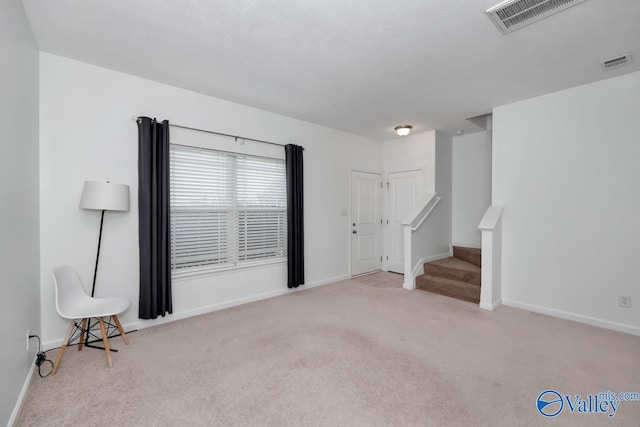 unfurnished living room with light carpet