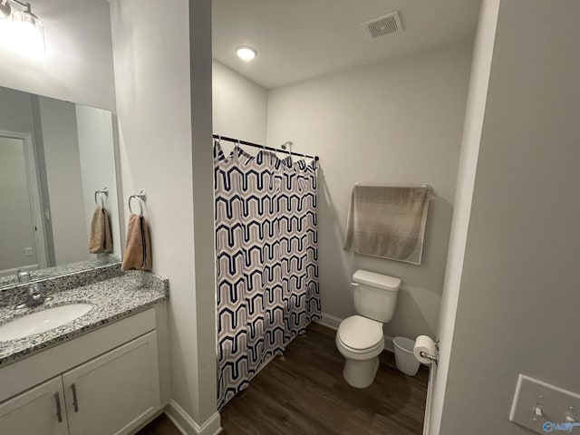 bathroom with toilet, wood-type flooring, a shower with shower curtain, and vanity