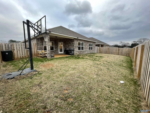 back of property with a patio and a lawn