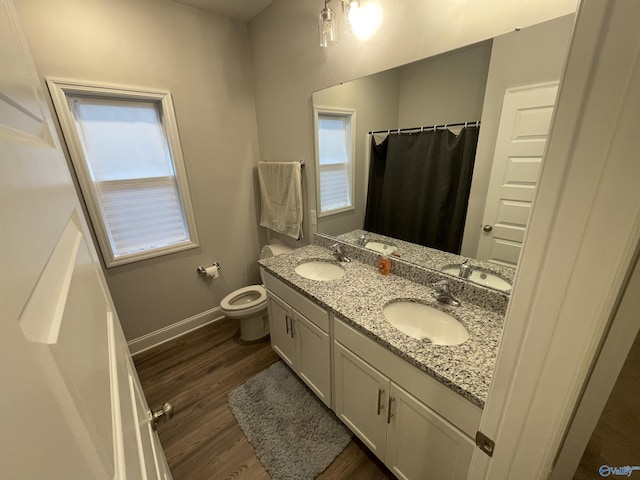 bathroom featuring vanity, walk in shower, toilet, and hardwood / wood-style floors