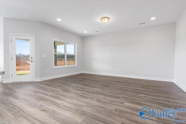 unfurnished room with hardwood / wood-style flooring