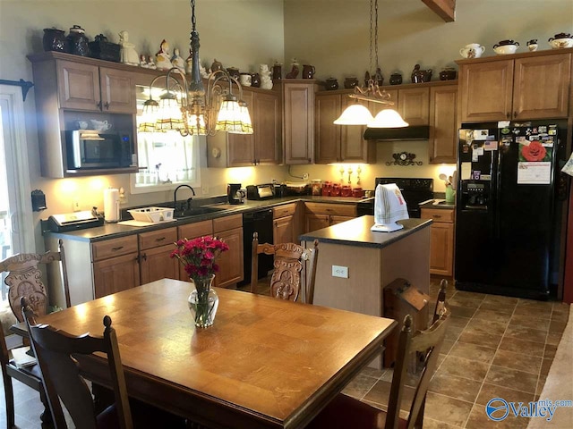 kitchen featuring sink, hanging light fixtures, a notable chandelier, a kitchen island, and black appliances