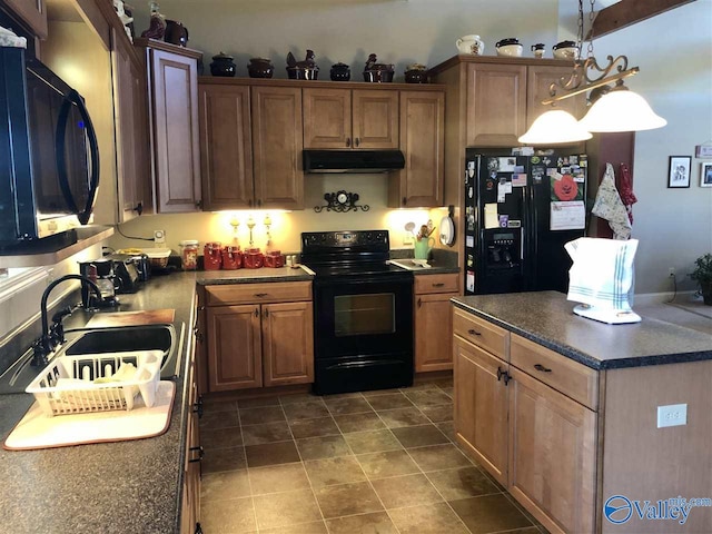 kitchen featuring black appliances, decorative light fixtures, sink, and exhaust hood