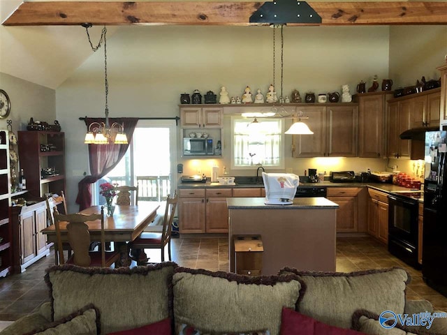 kitchen featuring sink, a center island, lofted ceiling with beams, a notable chandelier, and black appliances