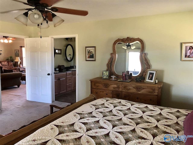 bedroom featuring connected bathroom, ceiling fan, and dark hardwood / wood-style flooring