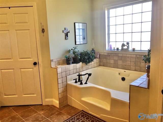 bathroom featuring tile patterned floors, a healthy amount of sunlight, and a bath