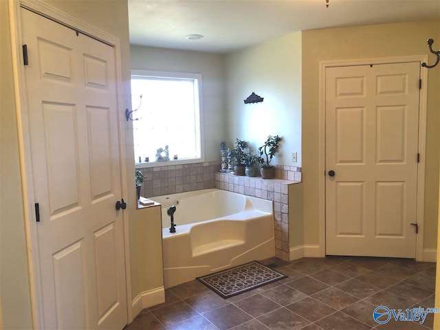 bathroom featuring tile patterned floors and a tub