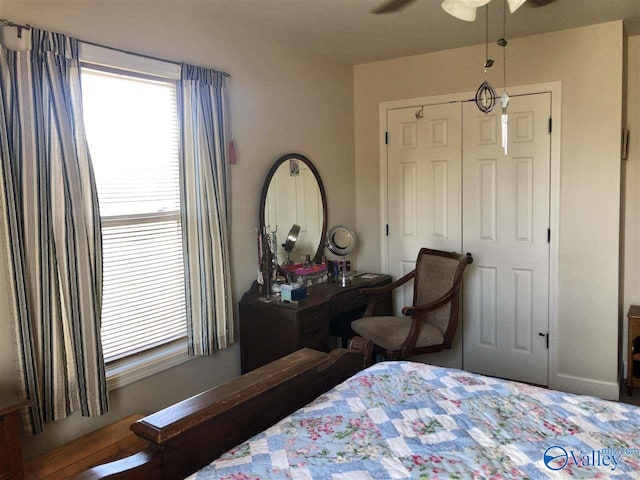 bedroom featuring ceiling fan and a closet