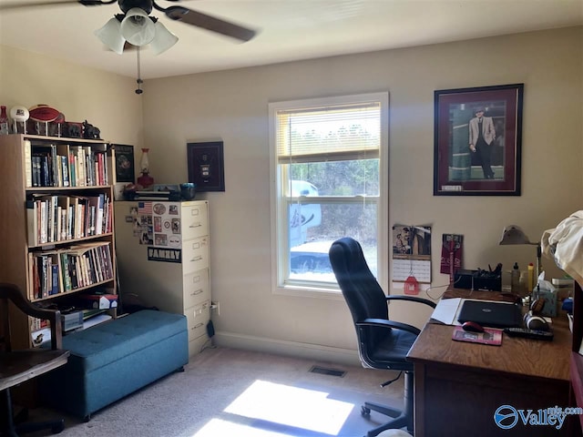 carpeted office featuring ceiling fan