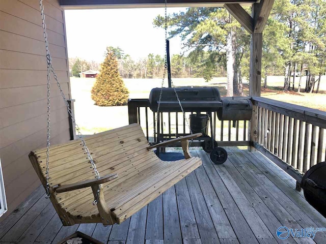 wooden terrace featuring a grill