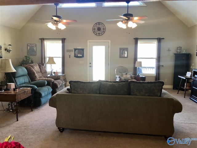 living room with high vaulted ceiling, light colored carpet, and a wealth of natural light