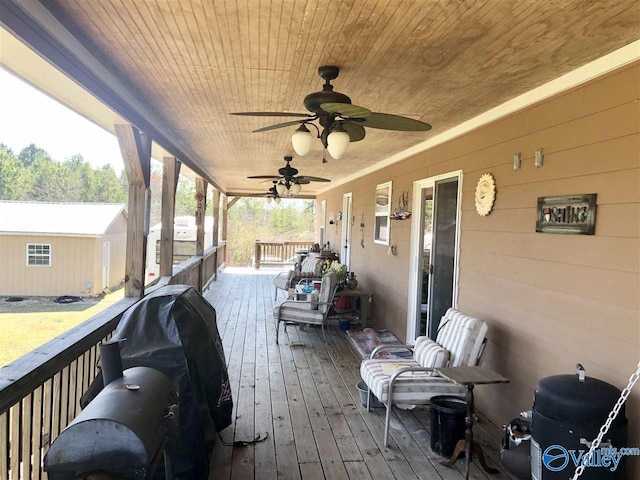 wooden terrace featuring a grill and a porch