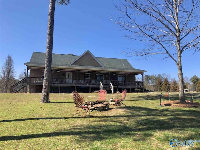 rear view of property with covered porch and a yard