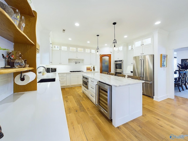 kitchen with wine cooler, white cabinetry, stainless steel appliances, and light hardwood / wood-style floors