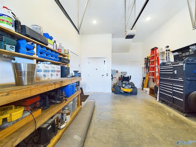 garage with a workshop area and a garage door opener