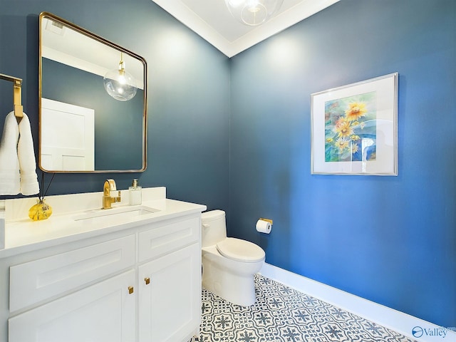 bathroom with vanity, toilet, and crown molding