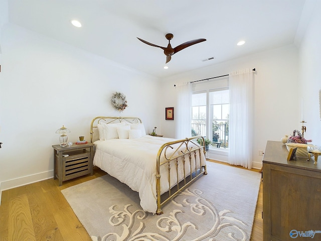 bedroom with ceiling fan and light hardwood / wood-style floors