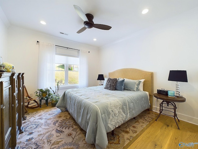 bedroom with ceiling fan and light hardwood / wood-style flooring