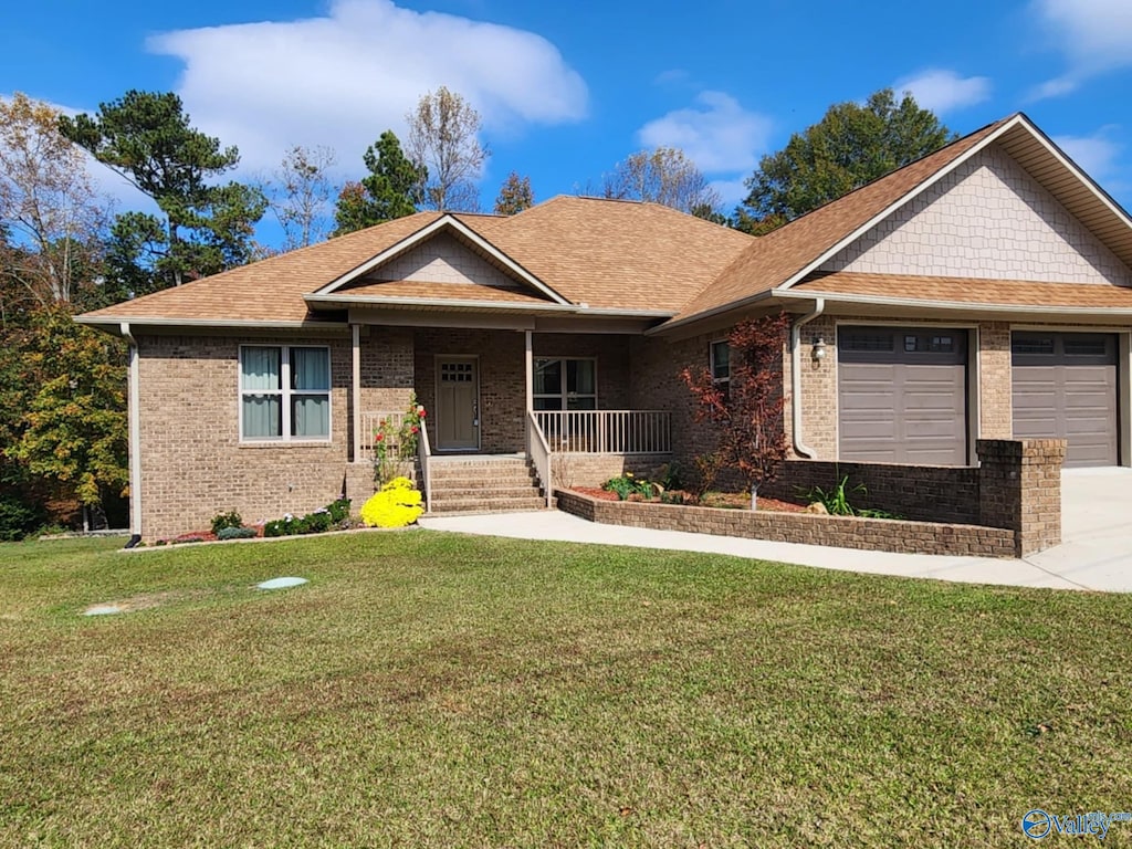 craftsman-style house with a front lawn, covered porch, and a garage