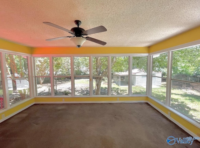 unfurnished sunroom with ceiling fan